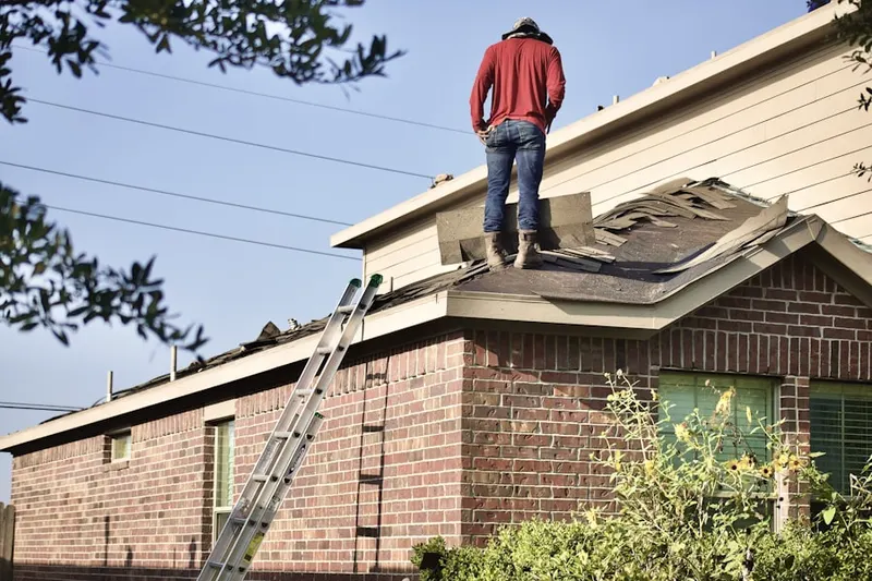 Professional roofer working on a residential roof in Moss Point